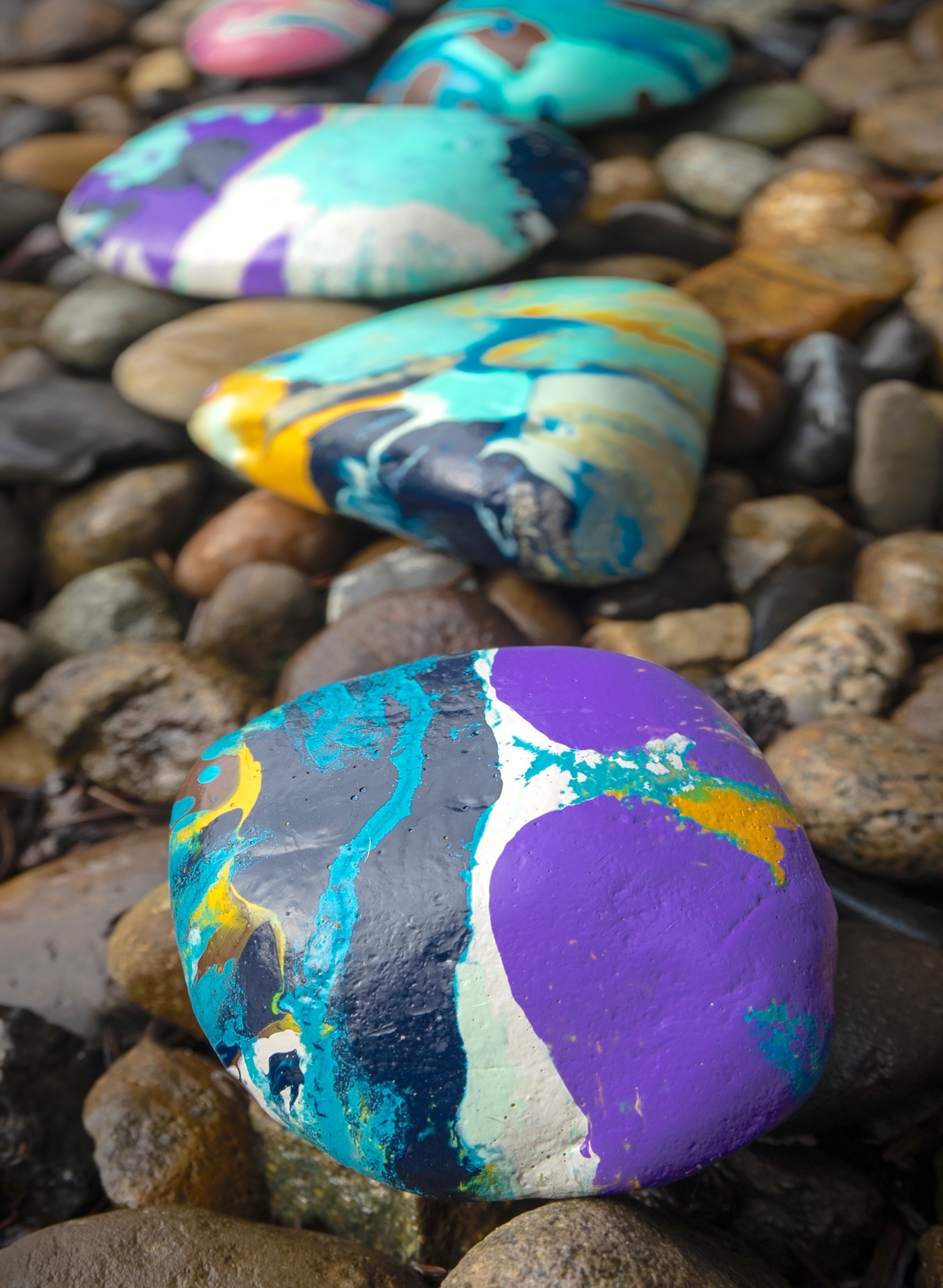 rocks painted with marbled paint