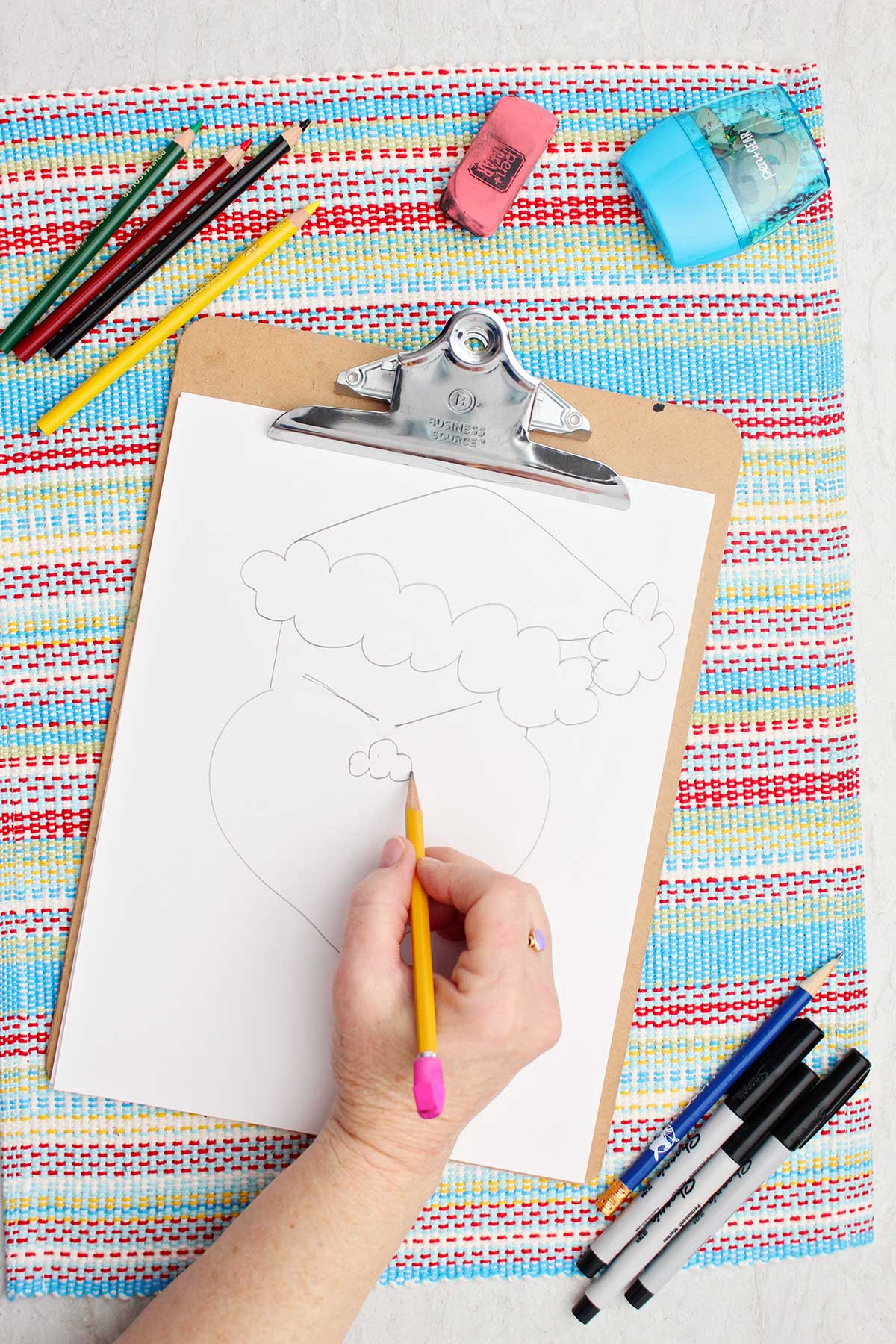 Person adding nose details to their Grinch sketch.