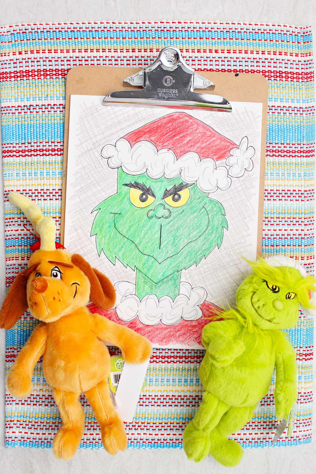 Colored in version of a Grinch sketch with Grinch and Max stuffed animals near by.