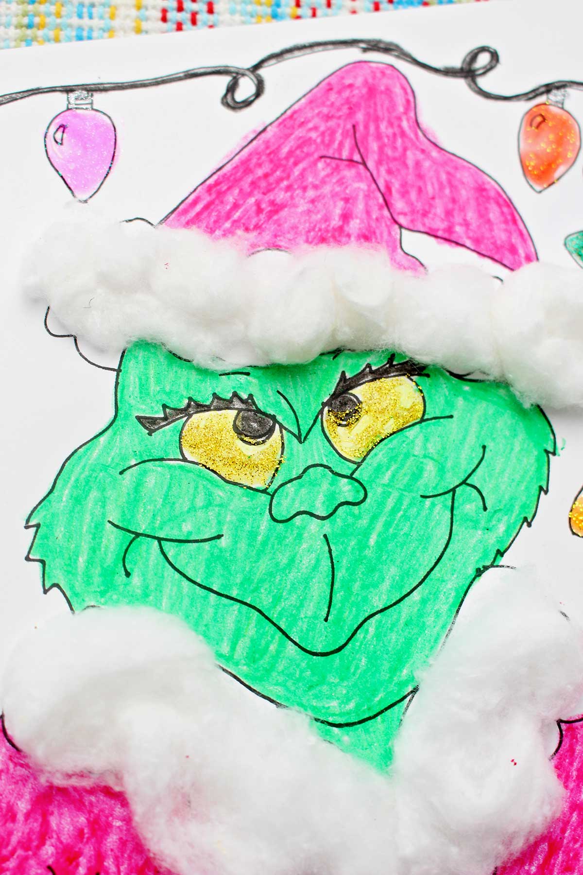 Close up of a completed Grinch coloring page.