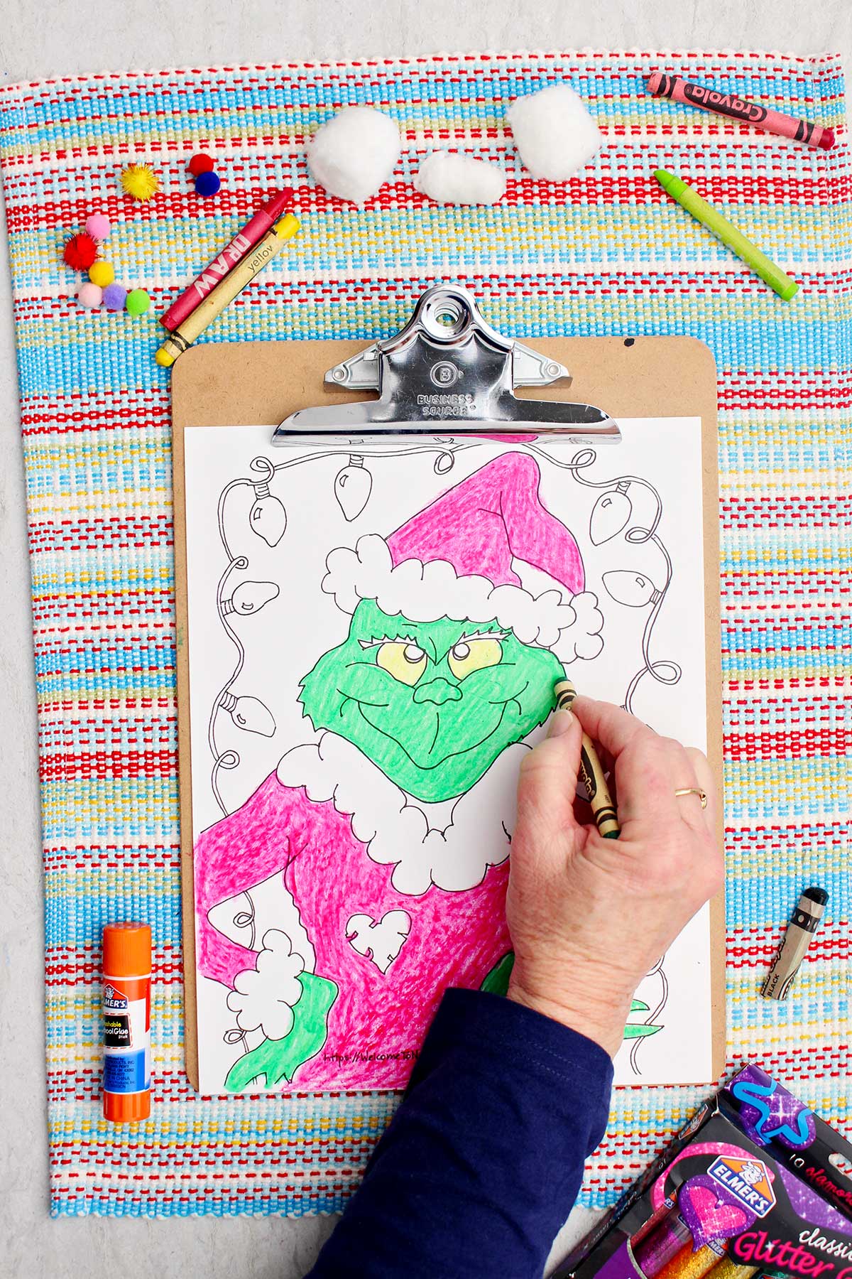 Person coloring The Grinch green on coloring page.