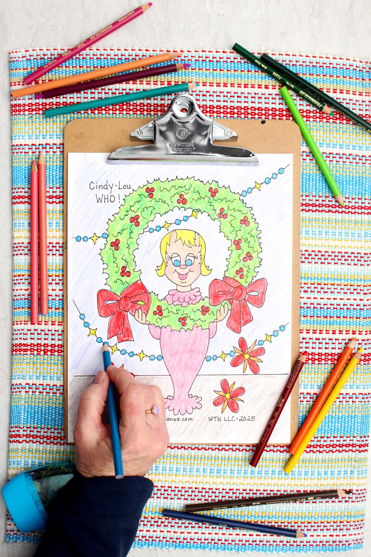 A coloring page of Cindy Lou Who and a Christmas wreath from How the Grinch Stole Christmas