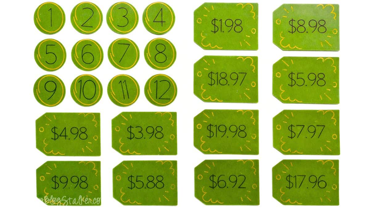 Numbered circles and price tag cards with dollar amounts used as pieces for a DIY Price Is Right style baby shower guessing game.