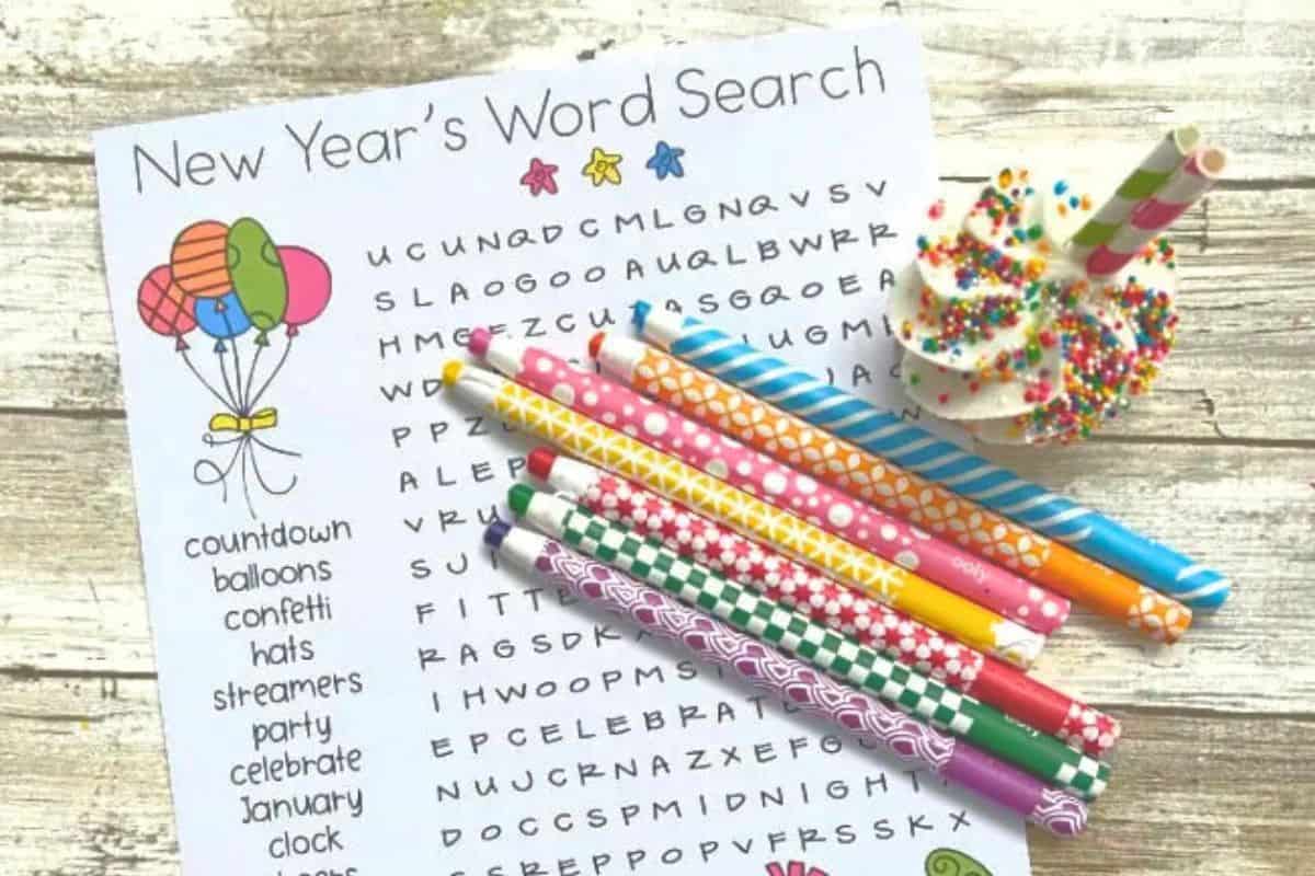 A printable New Year's word search featuring festive words like "countdown" and "party," colorful pencils, and a sprinkle-covered treat with striped straws on the side.