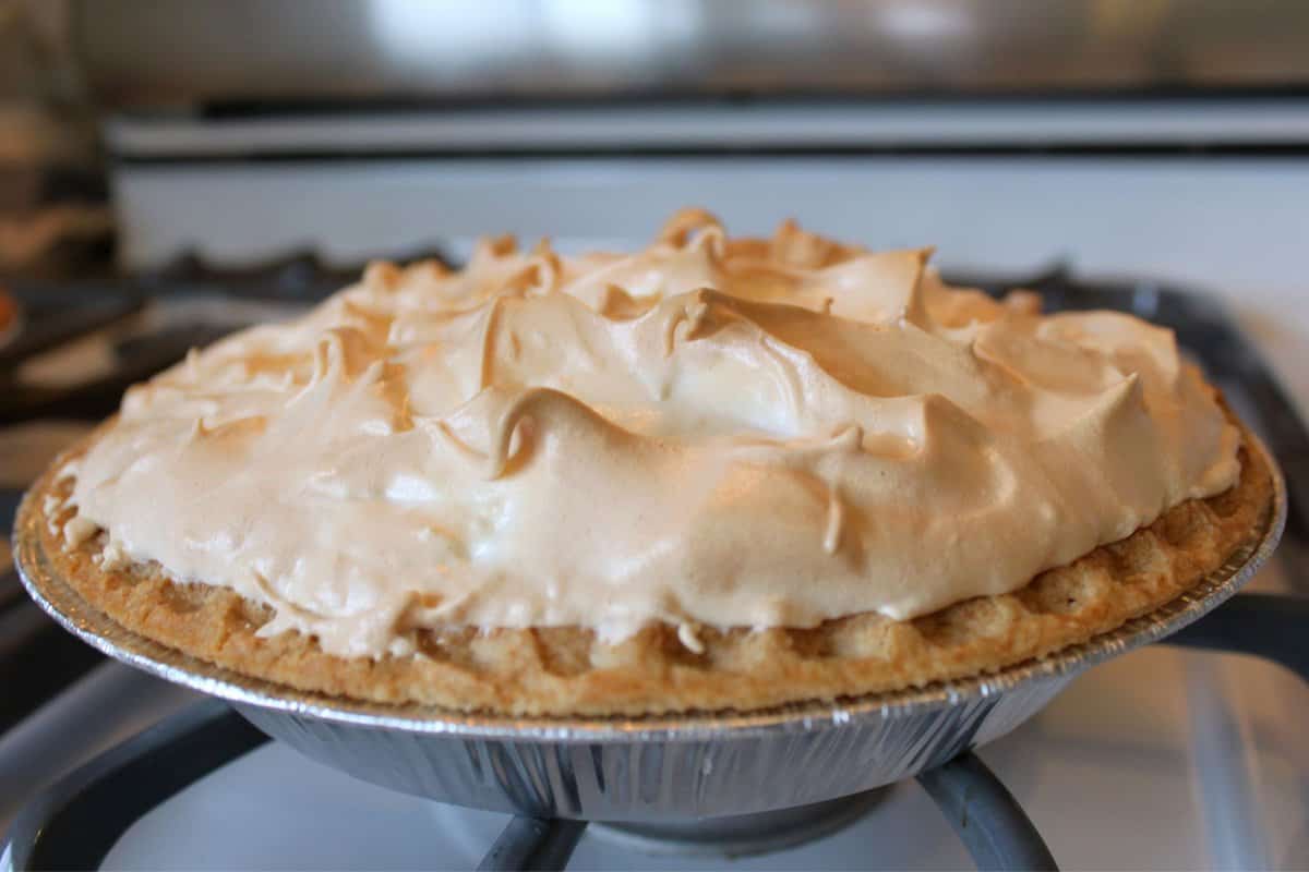 Lemon meringue pie on a stove.