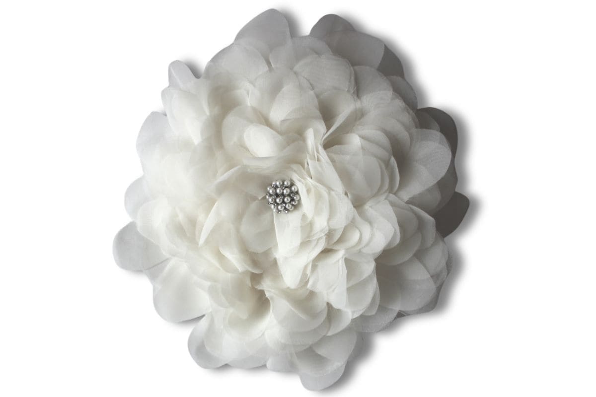 Large handmade fabric flower with layered petals and a pearl center embellishment, photographed on a white background as a decorative craft bloom.