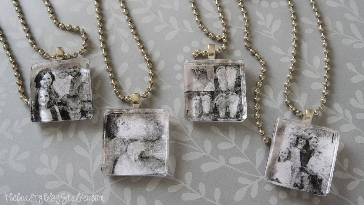 Handmade photo pendant necklaces with square glass tiles and silver chains, featuring black and white family and baby pictures.
