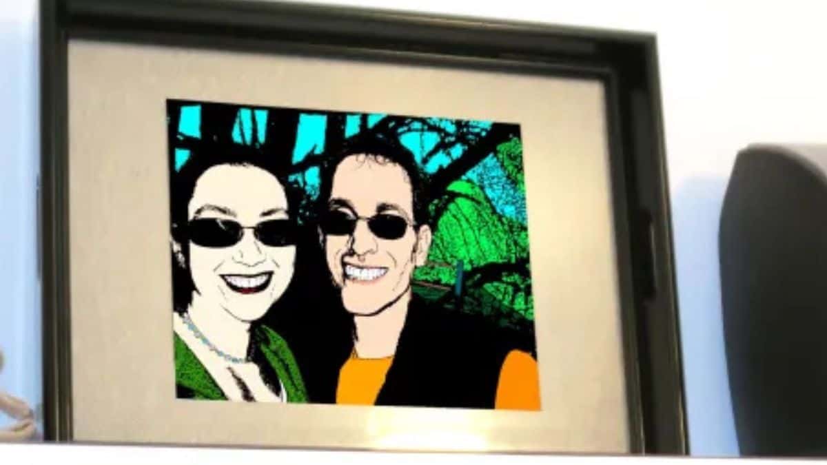 A framed pop-art style portrait of a smiling couple displayed inside a shallow tray-like frame.