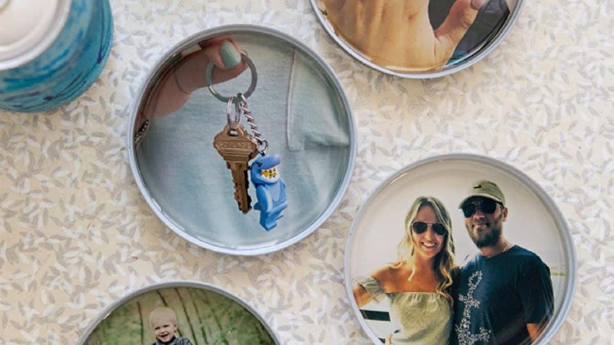 Circular mason jar lid coasters displaying personal photos, arranged on a patterned surface as a DIY home décor project.