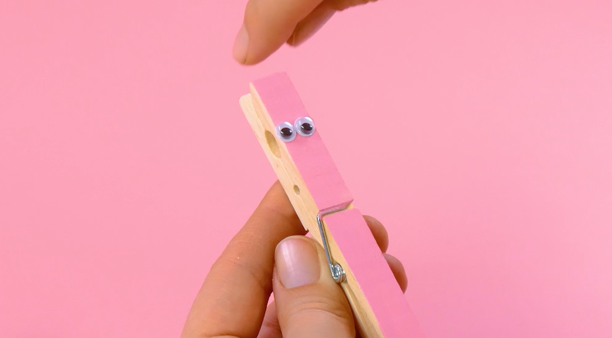 Paint a clothespin and attach two googly eyes to it.