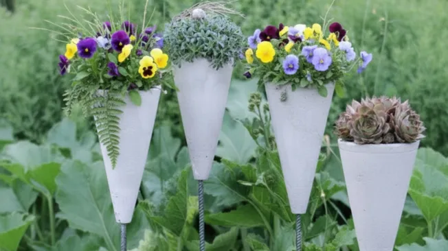 four concrete garden stakes