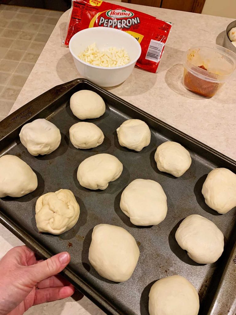homemade pizza pockets on a baking sheet.